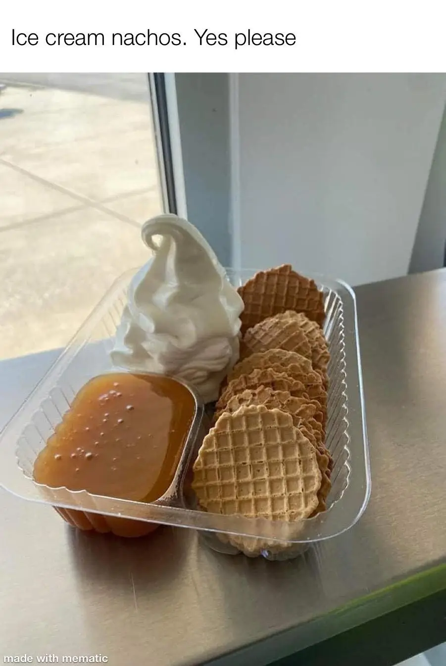 A clear plastic container holds a serving of soft-serve vanilla ice cream, a side of caramel sauce, and a pile of waffle…