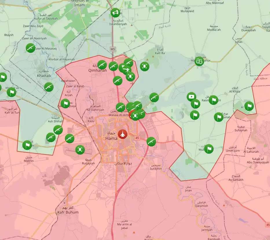 A map of Hama, Syria, shows a dense cluster of green icons representing military positions or checkpoints, with the city…
