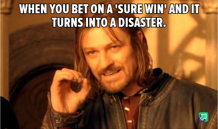 A man with long brown hair and a beard, wearing a dark leather jacket over a red shirt, looks at the camera with a smug…
