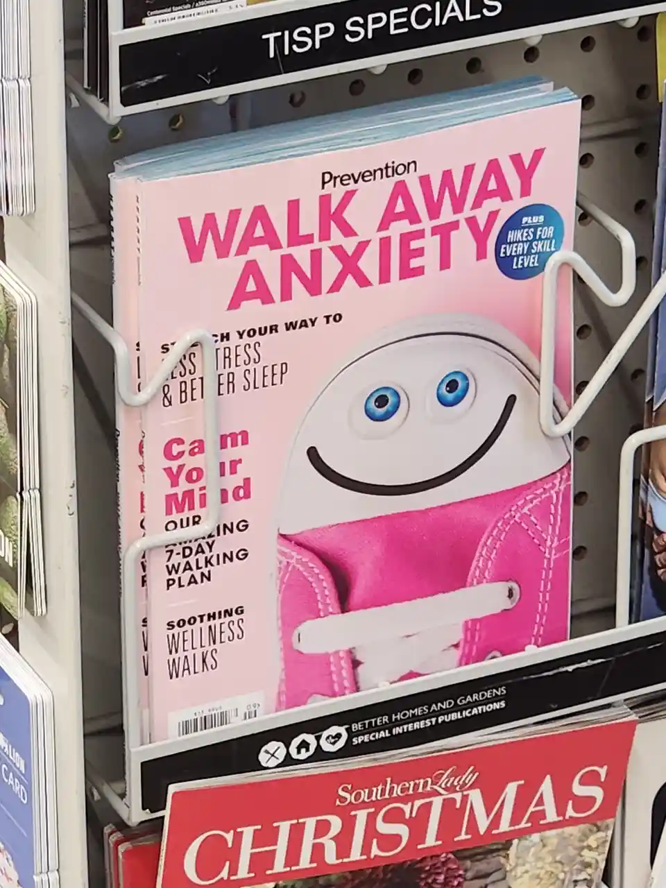 A magazine titled 'Prevention' with the headline 'WALK AWAY ANXIETY' is displayed in a store rack. The cover features a…