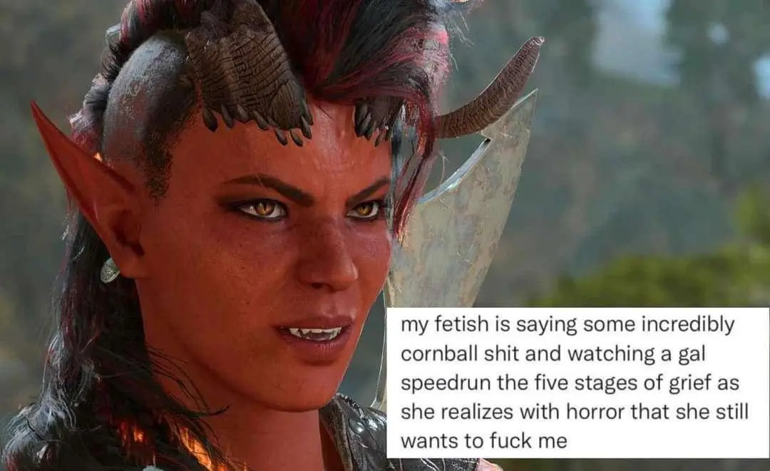 A close-up of a female elf-like character with red skin, pointed ears, horns, and a shaved head with braids, holding a…