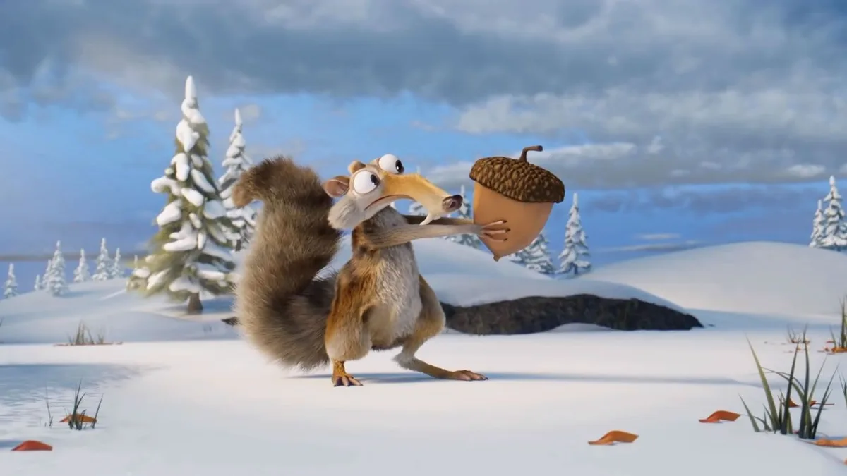 An animated squirrel with a large bushy tail stands in a snowy landscape holding an acorn with both hands, looking…
