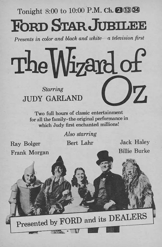 A vintage black-and-white TV advertisement for 'The Wizard of Oz' starring Judy Garland, featuring images of the main…