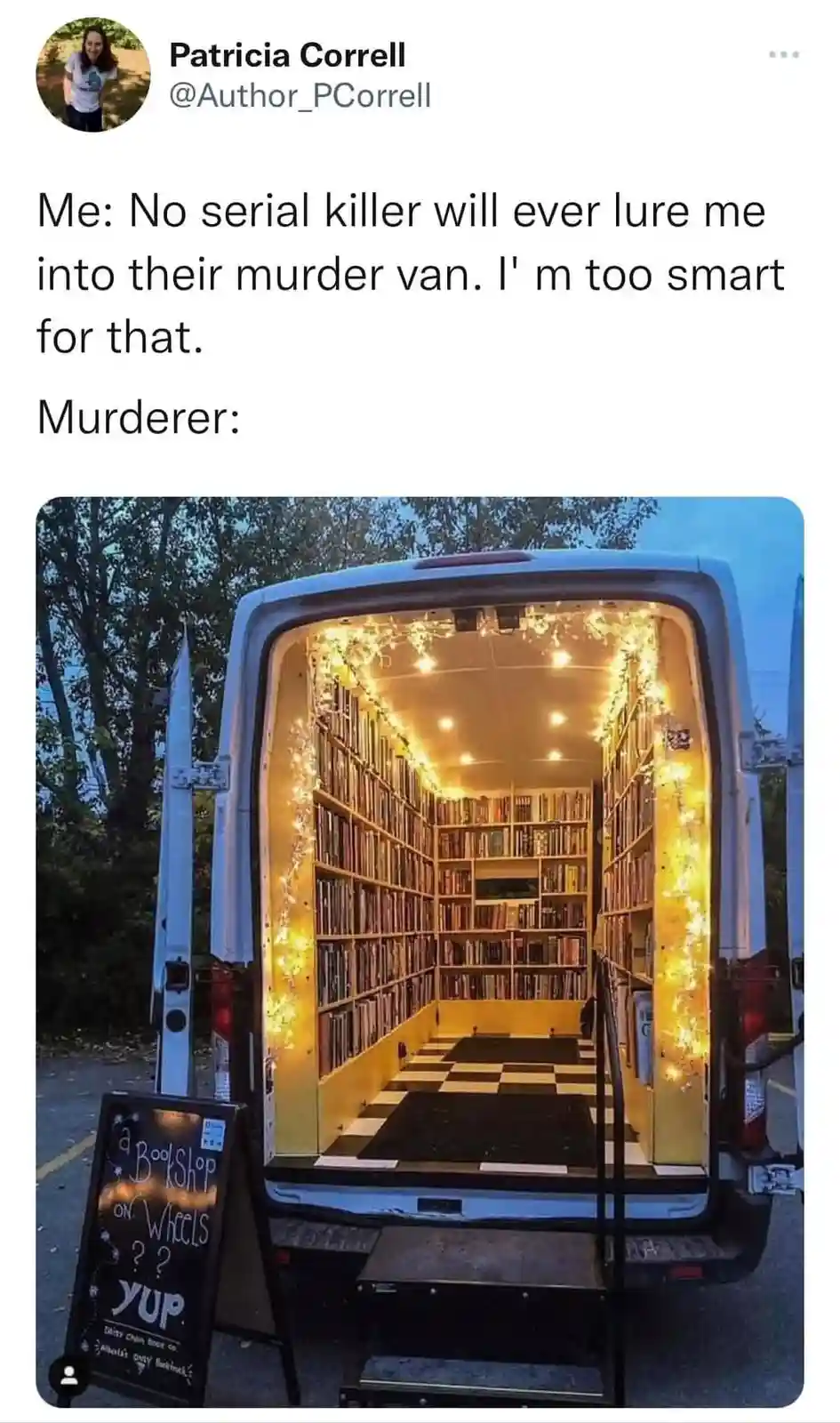 A white van with its rear doors open reveals a cozy, well-lit interior transformed into a bookstore, complete with…