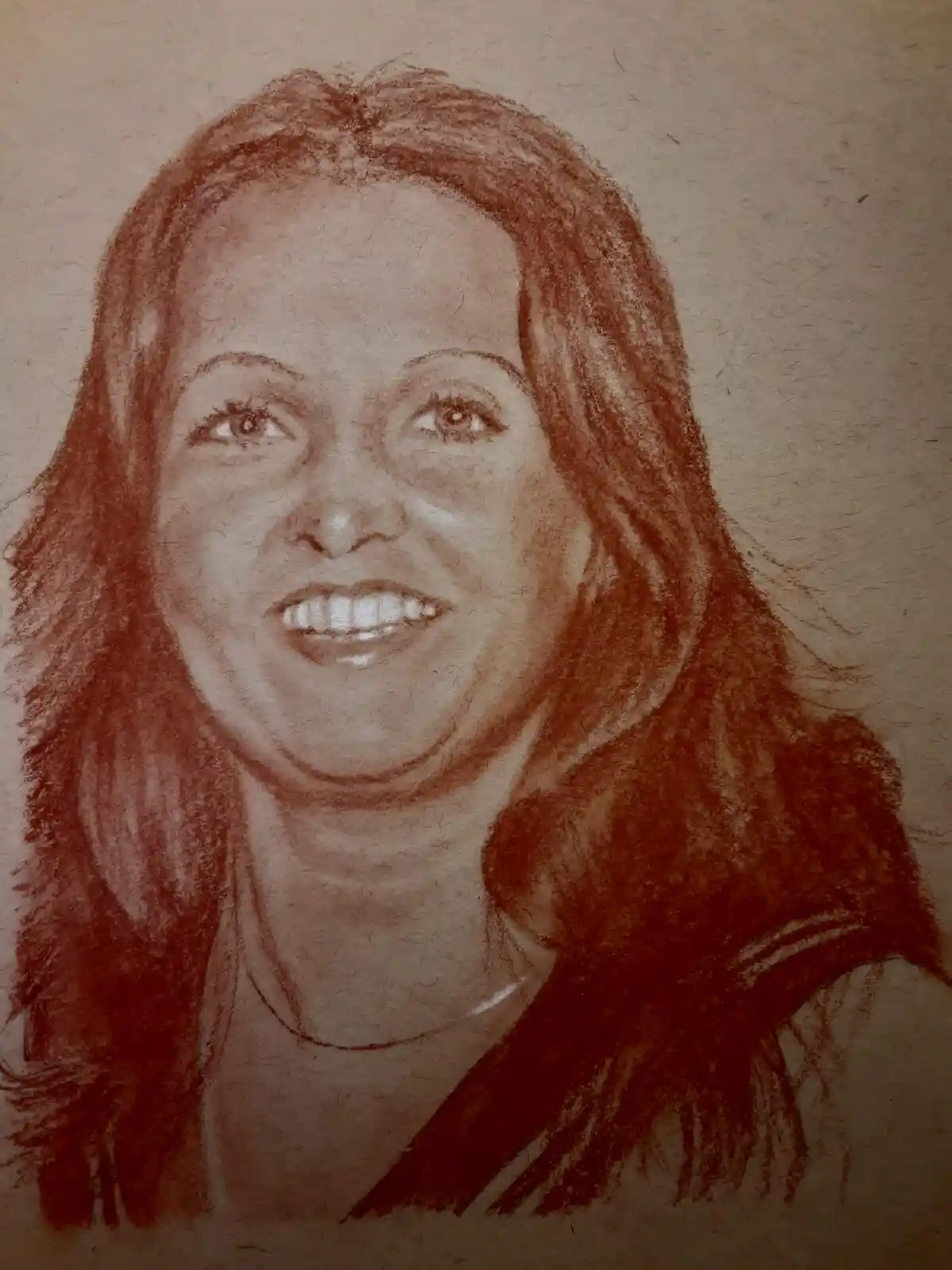 A red chalk portrait of a smiling woman with long hair, drawn on textured brown paper. The overlaid text reads: 'i drew this…