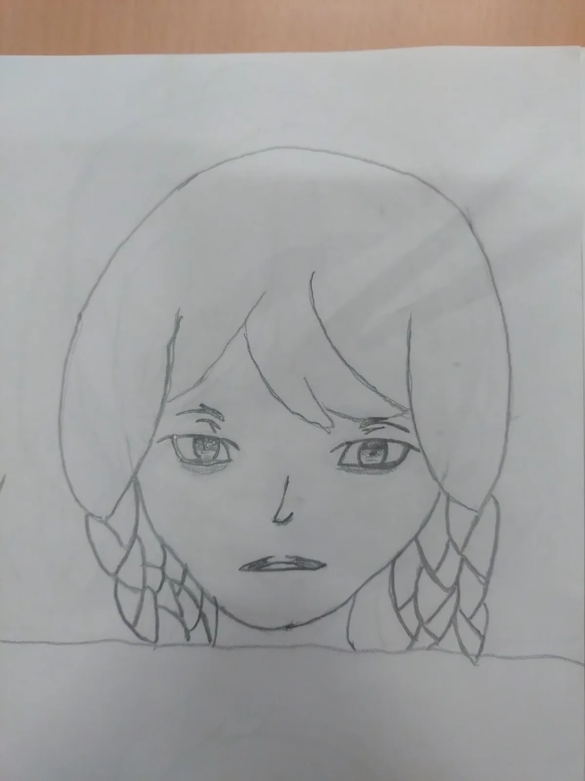 A hand-drawn pencil sketch on white paper shows a stylized anime-style girl's face with short hair and two braids, set…