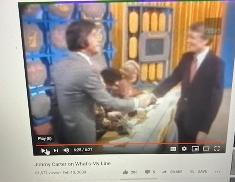 A low-resolution video screenshot from a 2009 YouTube clip shows former president jimmy carter in a suit shaking hands with…