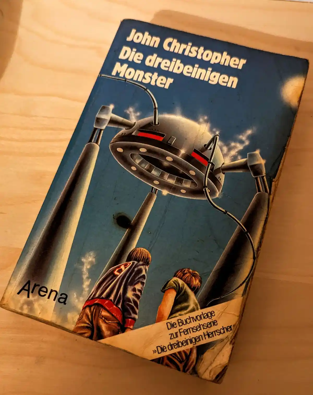 A German-language paperback book titled 'John Christopher Die dreibeinigen Monster' (John Christopher The Three-Legged…