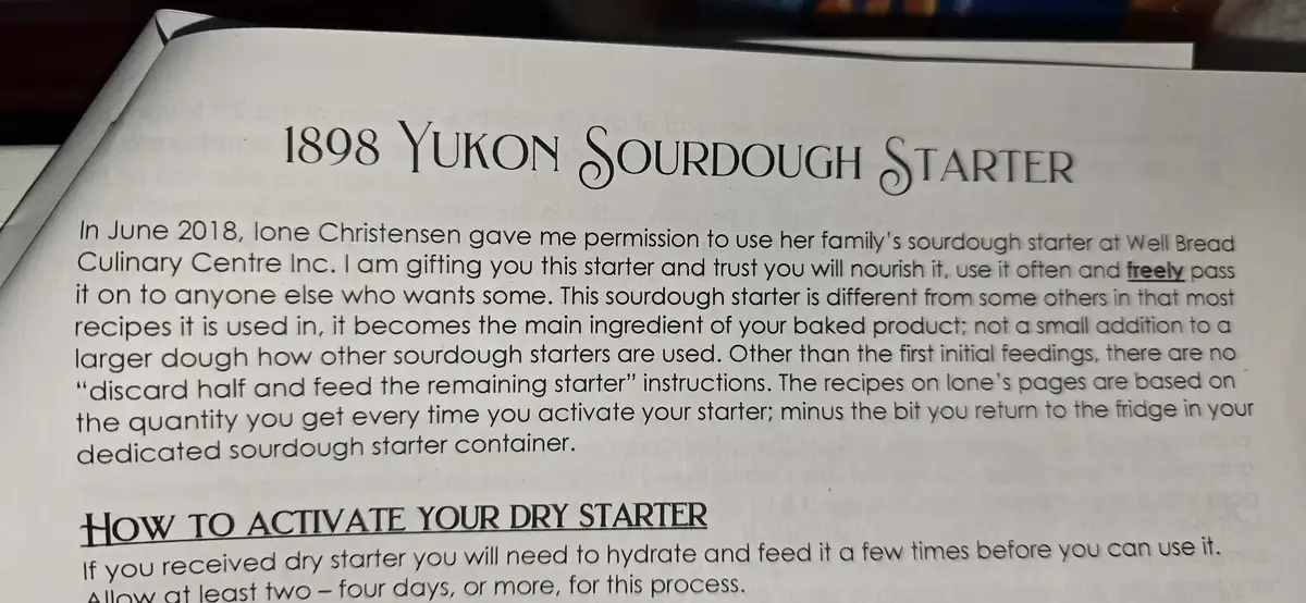 A close-up of a printed document titled '1898 Yukon Sourdough Starter' that explains how to activate a dry sourdough…