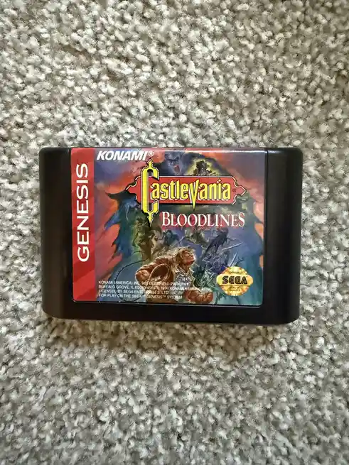 A Sega Genesis game cartridge for 'Castlevania: Bloodlines' by Konami, featuring artwork of a warrior battling monsters…