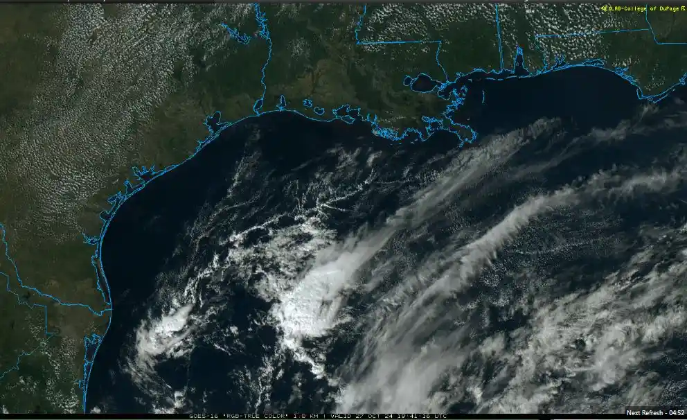 A satellite weather image shows a large storm system over the Gulf of Mexico near the U.S. Gulf Coast, with blue outlines…