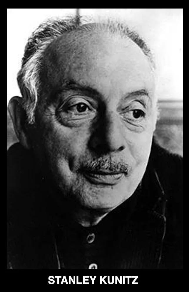 A black and white portrait of an elderly man with a mustache, wearing a dark collared shirt, looking directly at the camera…
