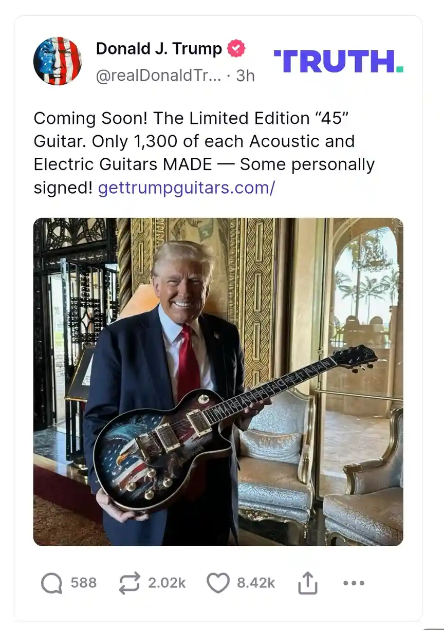 A screenshot of a social media post by Donald J. Trump, showing him smiling while holding a guitar decorated with an…