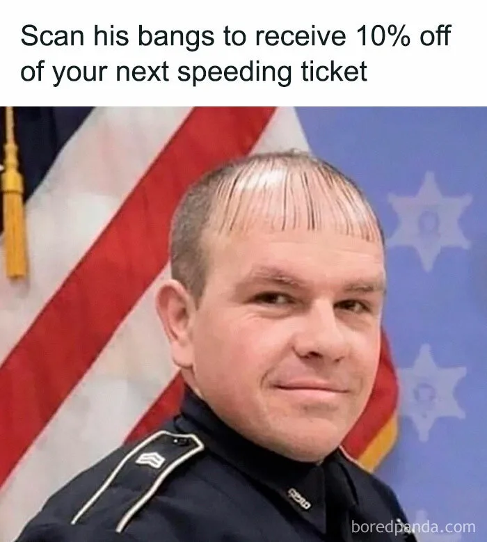 A man in a police uniform with a very distinct, straight, thin fringe of hair on his forehead, standing in front of an…