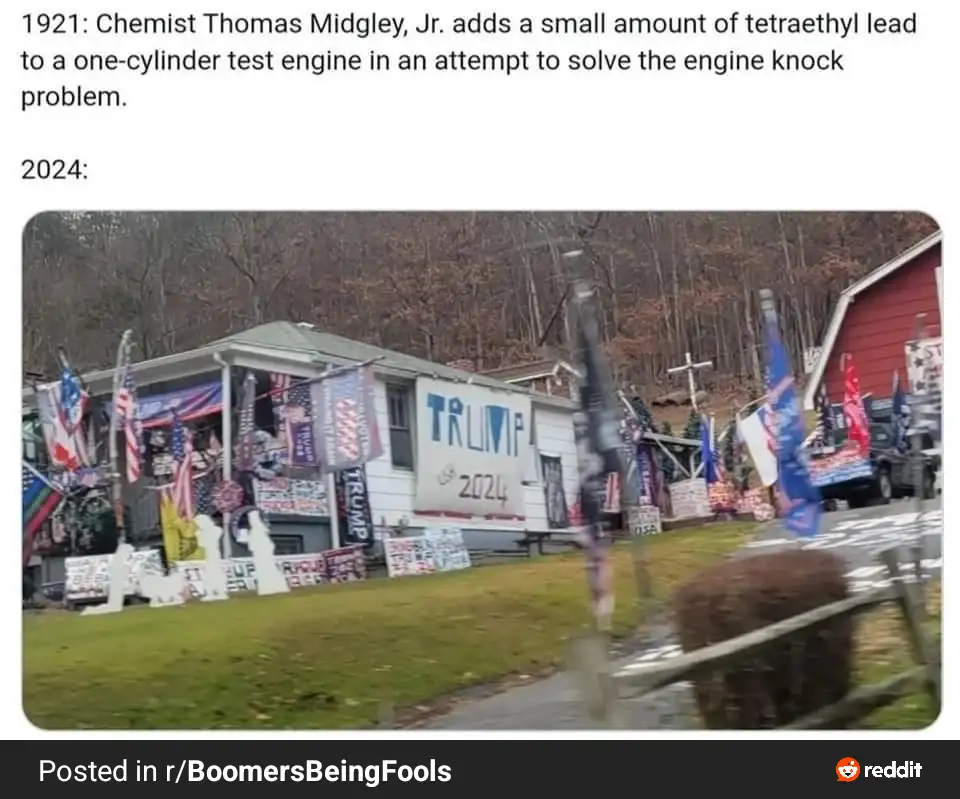 The image shows a house covered in Trump 2024 campaign signs and flags, with a large 'TRUMP 2024' banner on the side. The…