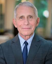 A professional headshot of Dr. Anthony Fauci, a senior U.S. health official, smiling slightly while wearing a dark suit…