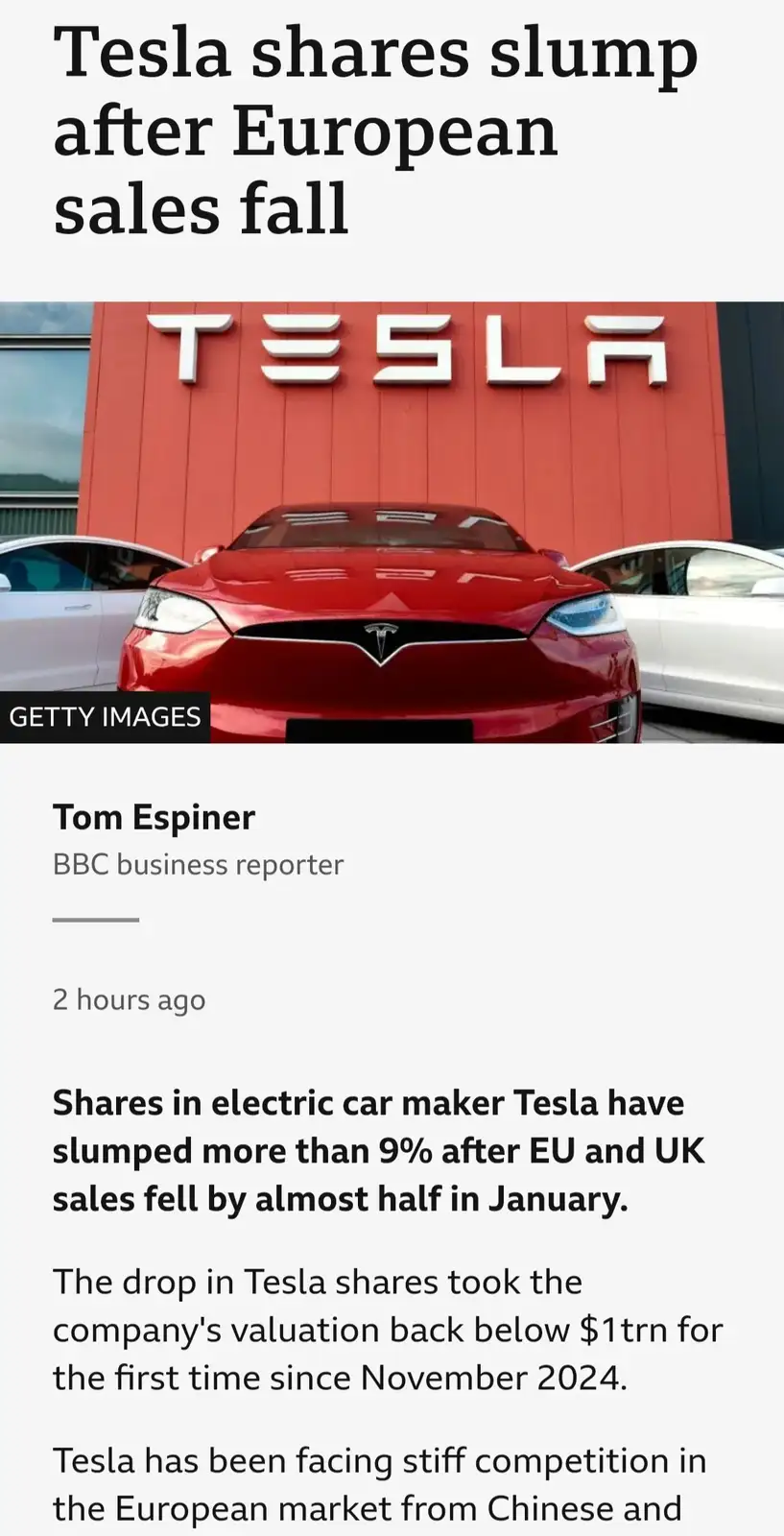 A screenshot of a BBC news article about Tesla's stock drop, featuring a red Tesla car in front of a red building with the…