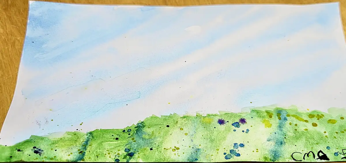 A watercolor painting on paper depicts a simple landscape with a blue sky and white clouds above a green, textured hillside…