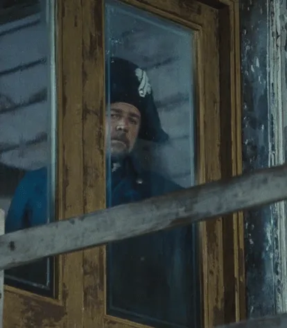 A six-panel grid shows actor Russell Crowe in a blue military uniform and tricorn hat, looking out from behind a wooden…