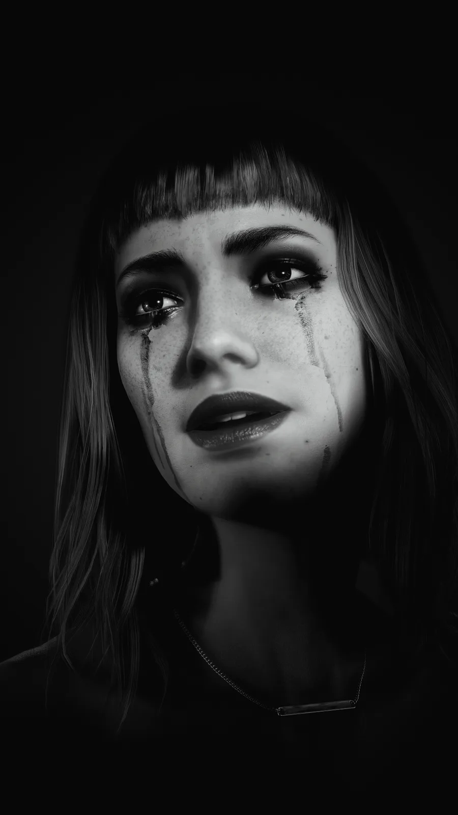 A black-and-white portrait of a woman with freckles, bangs, and tears streaming down her face, looking upward with a…