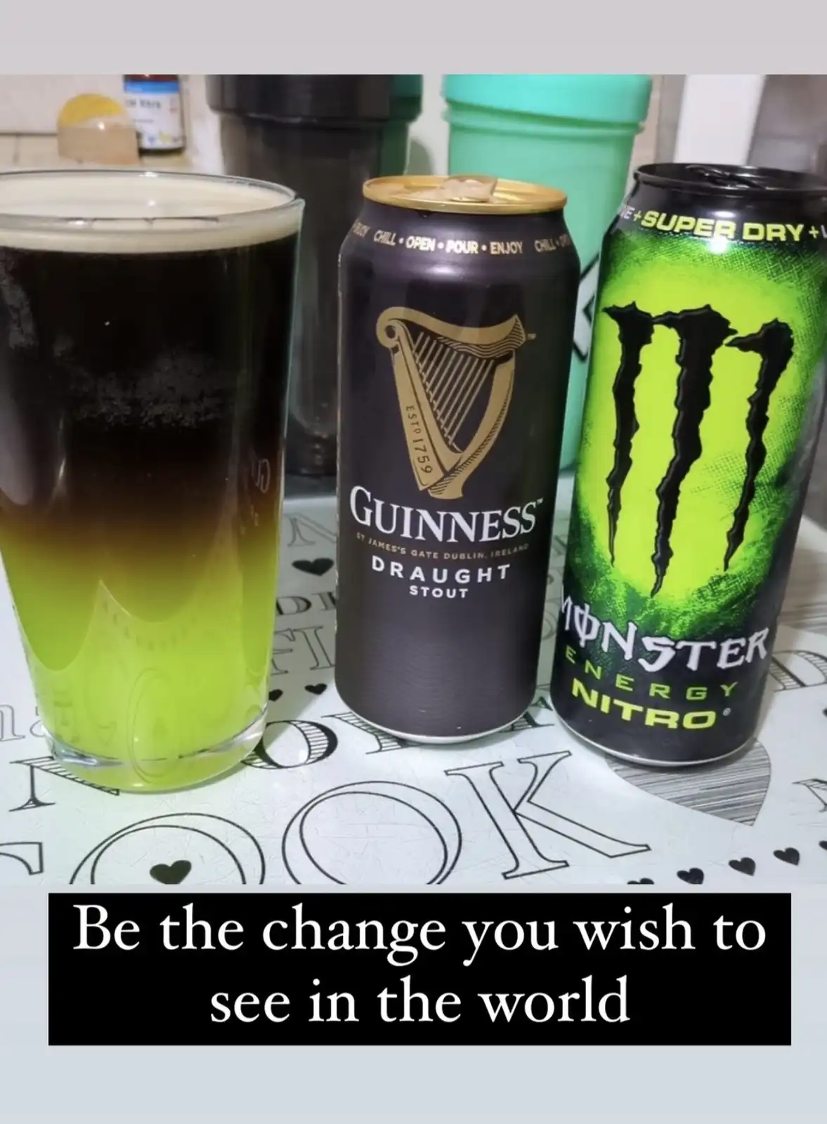 A glass of Guinness beer has been mixed with a can of Monster Energy Nitro, creating a greenish-yellow drink. Next to it are…