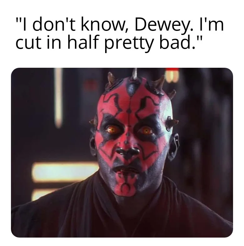 A close-up image of the character Darth Maul from Star Wars, showing his red and black face paint, horns, and glowing orange…