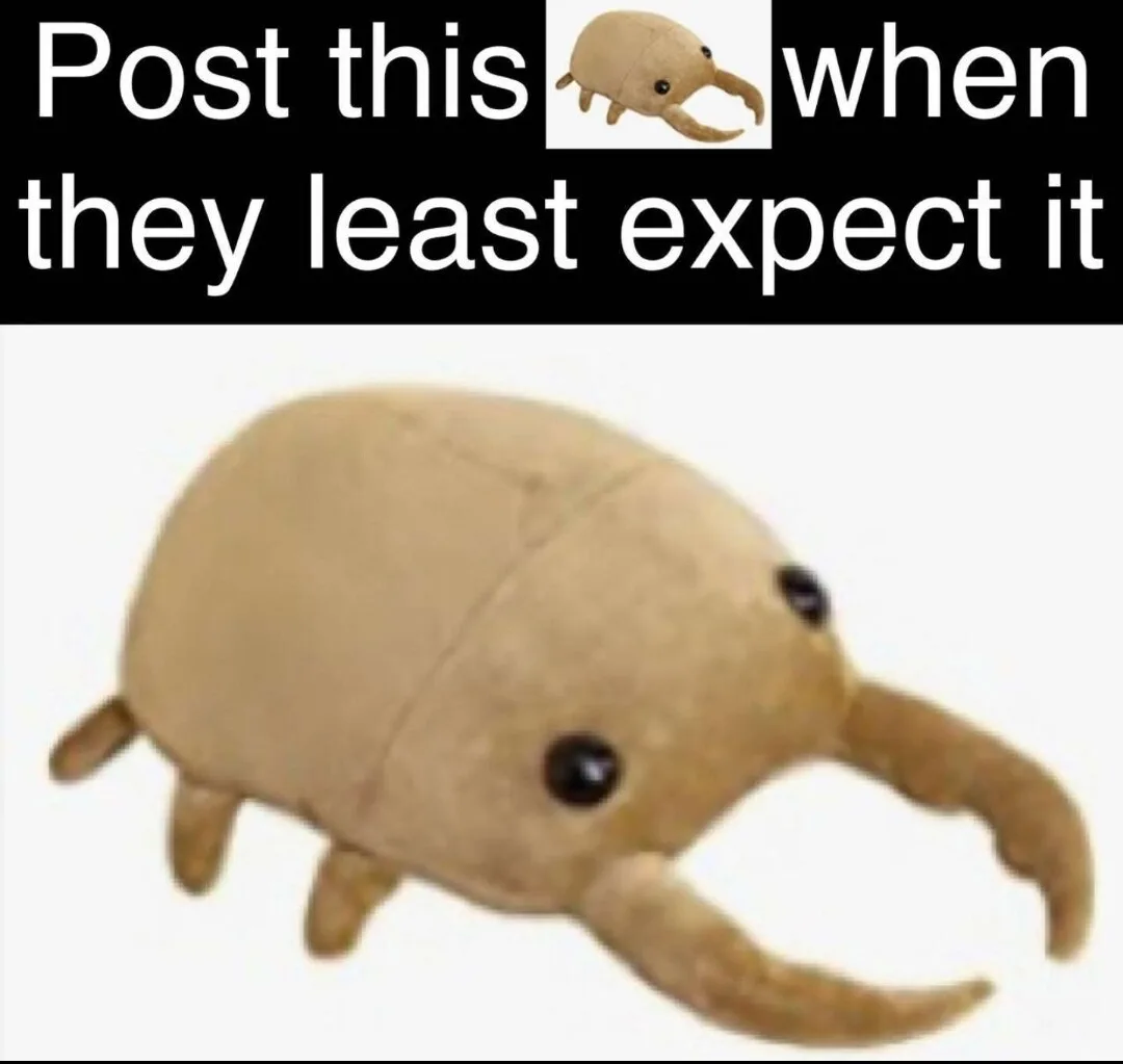 The image displays a beige plush toy resembling a small, cute arthropod with large black eyes, two prominent curved claws…