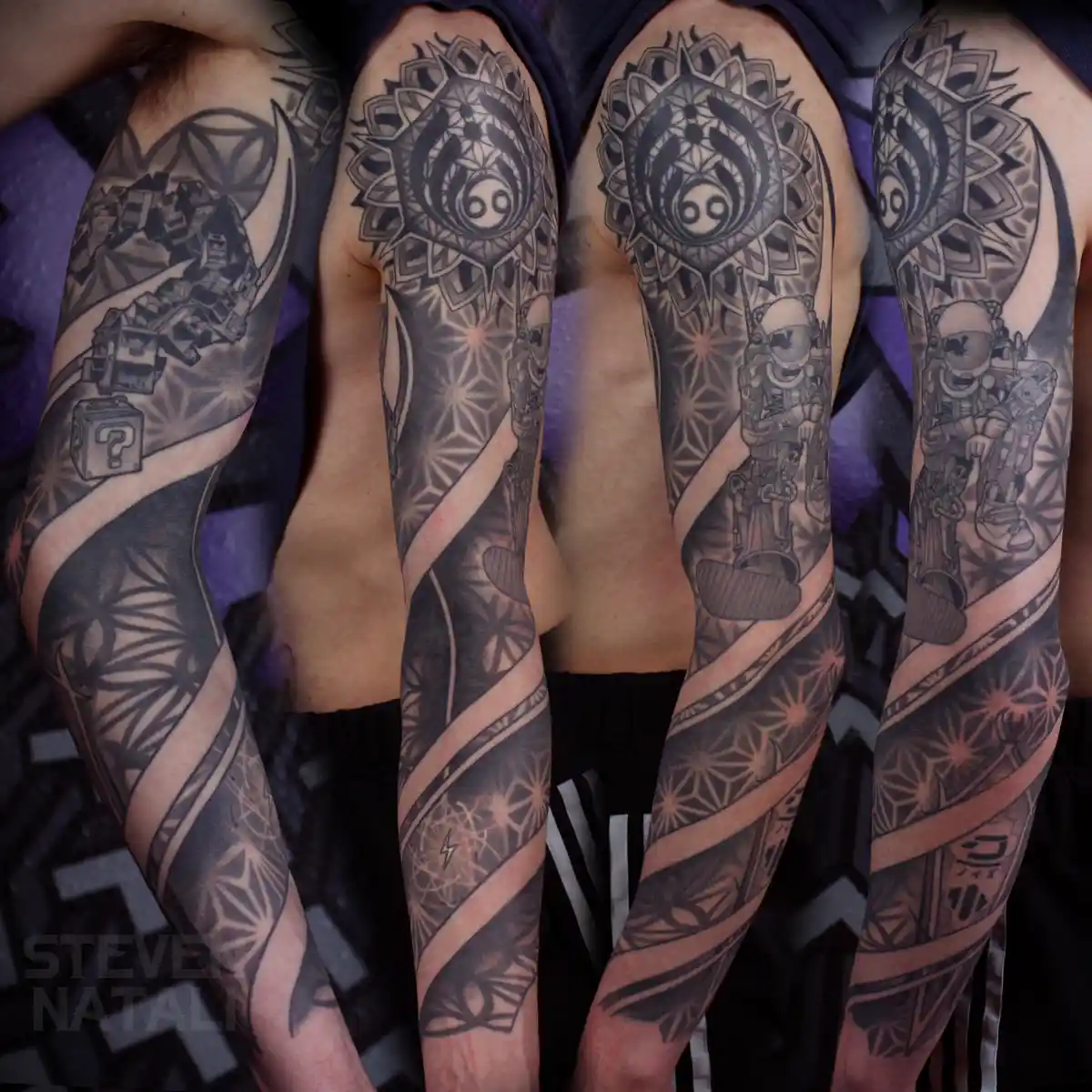 Four identical arms are shown side-by-side, each covered in a detailed black-and-gray sleeve tattoo featuring a central…