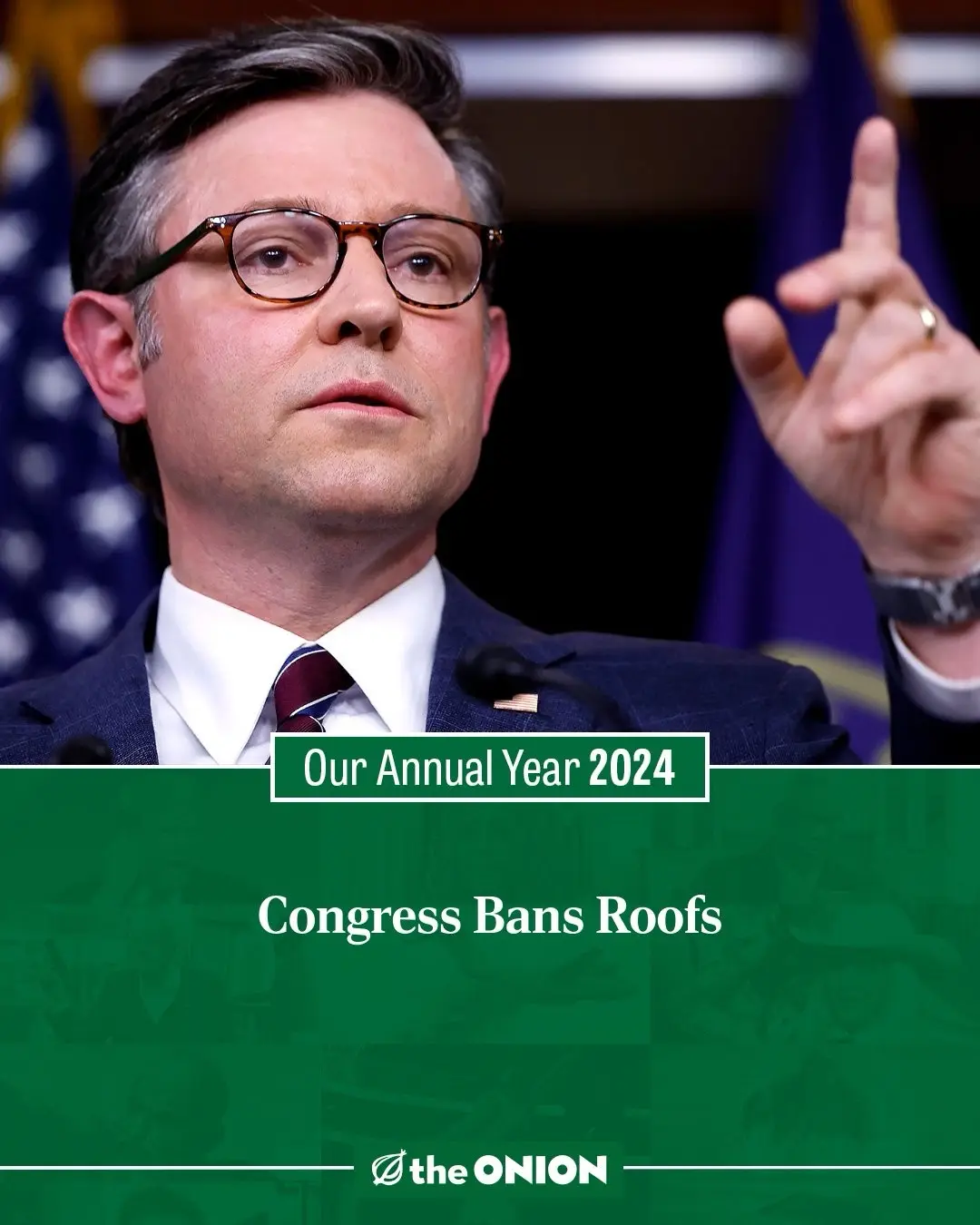A man in a suit and glasses, gesturing with his index finger raised, is shown against a backdrop of American flags. Overlaid…