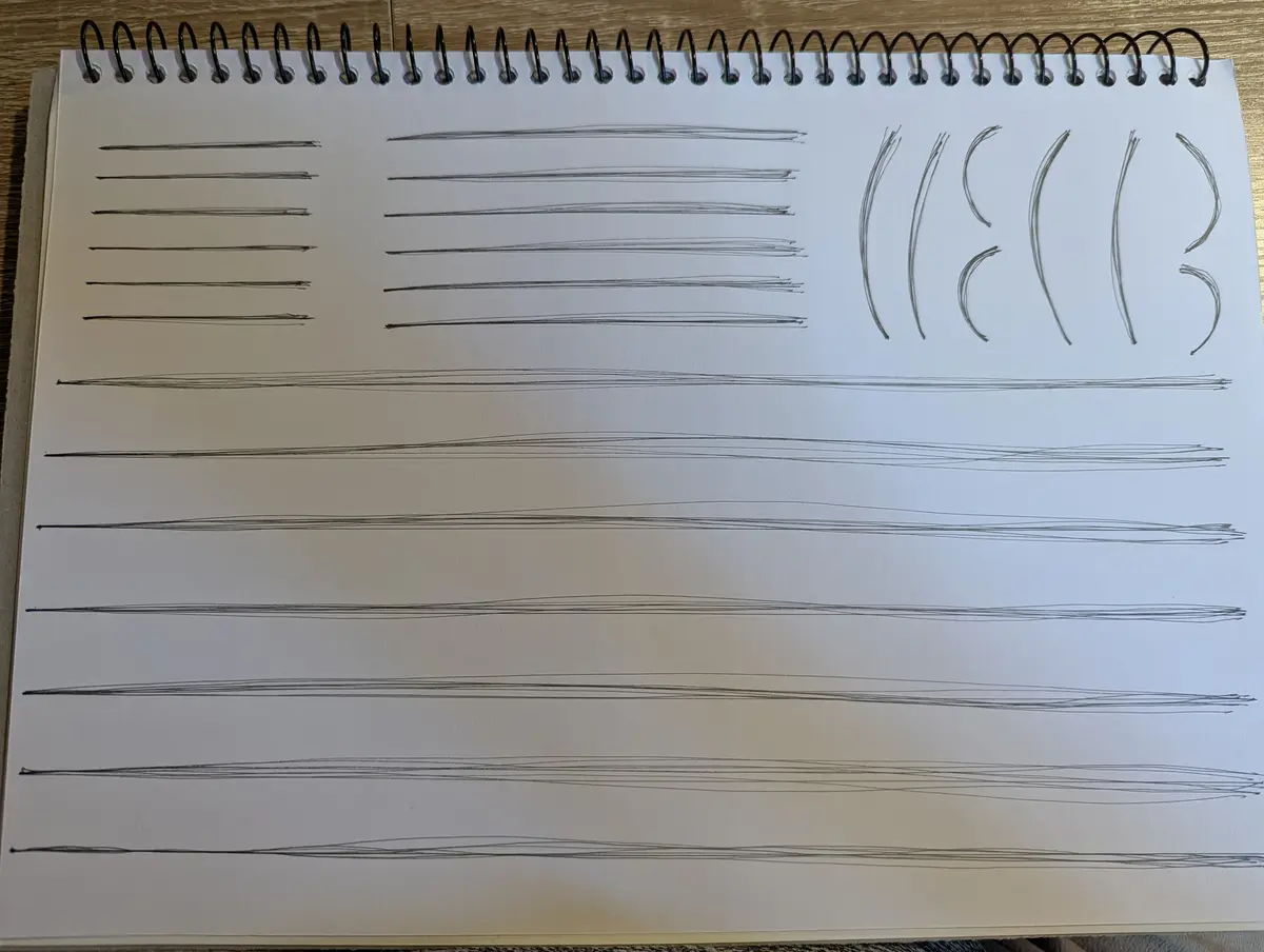 A spiral-bound notebook page shows multiple attempts at drawing straight horizontal lines with a pencil, progressing from…