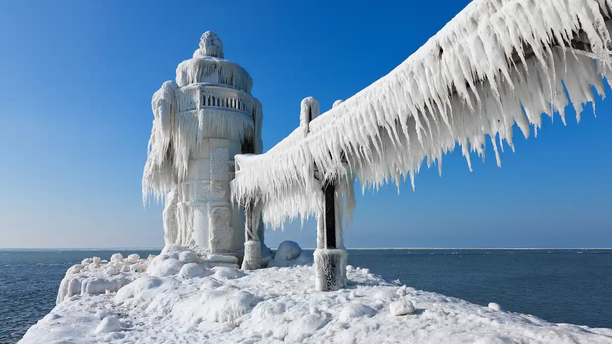 Frosty winds from Lake Michigan whip St. Joseph's North Pier Outer Light, causing it to stand sturdy, but alone, since its…