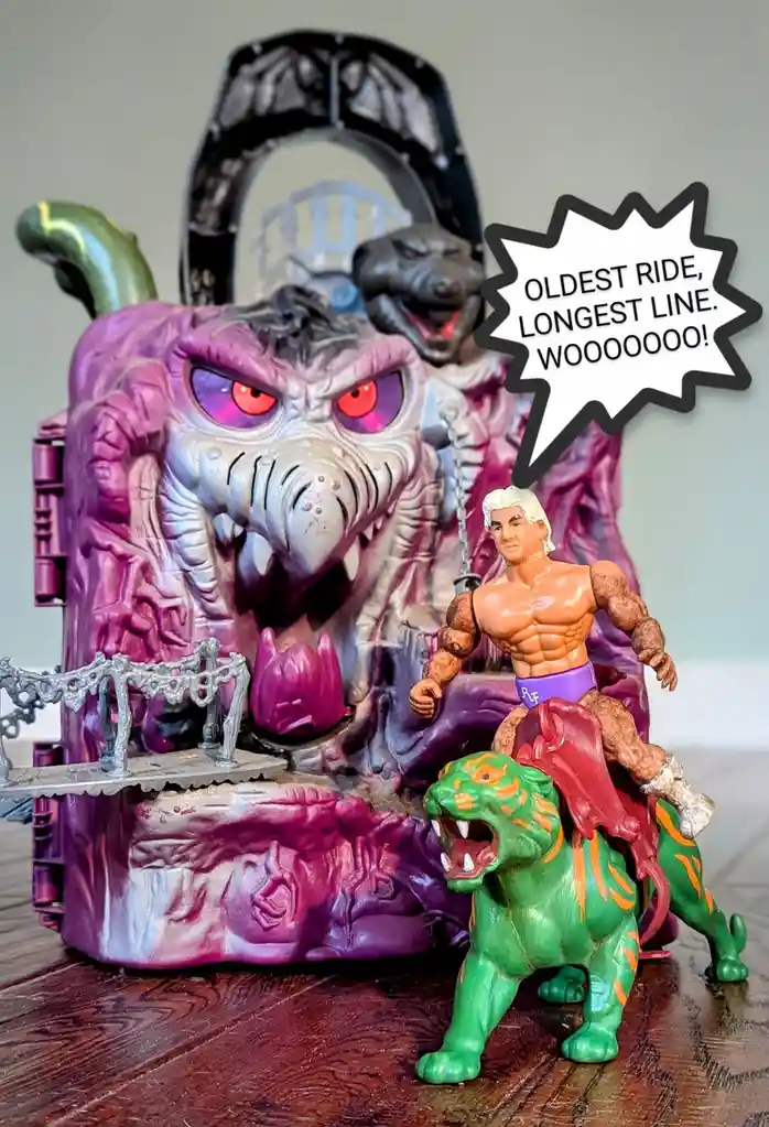 A toy photo shows a muscular action figure with white hair riding a green, orange-striped tiger-like creature in front of a…