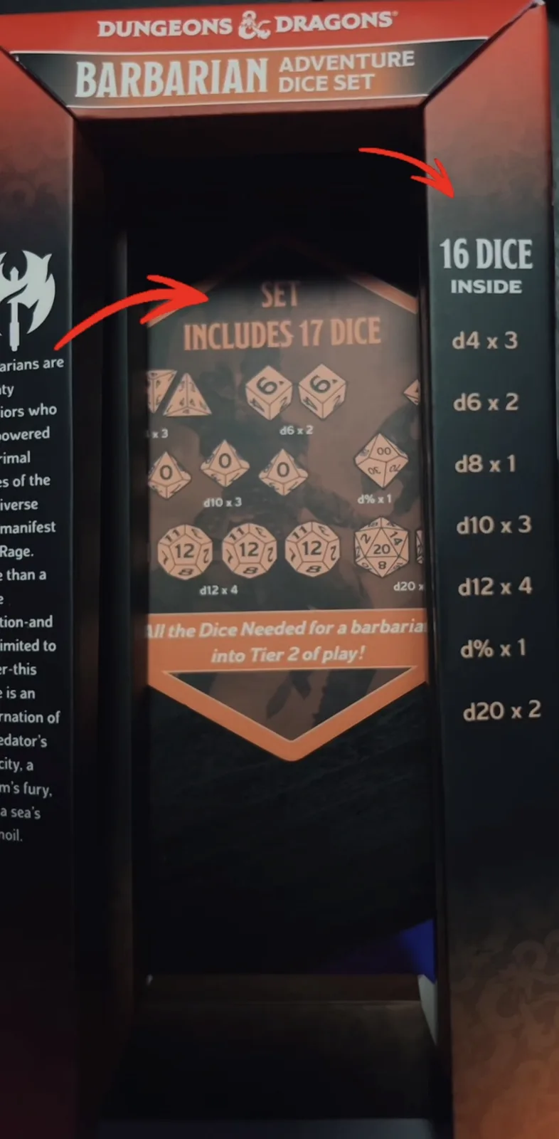 A close-up of a Dungeons & Dragons Barbarian Adventure Dice Set box, where red arrows point to conflicting text: one says…