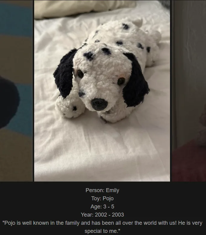 A close-up photo of a white, fluffy, crocheted dalmatian plush toy with black spots and floppy black ears, lying on a white…