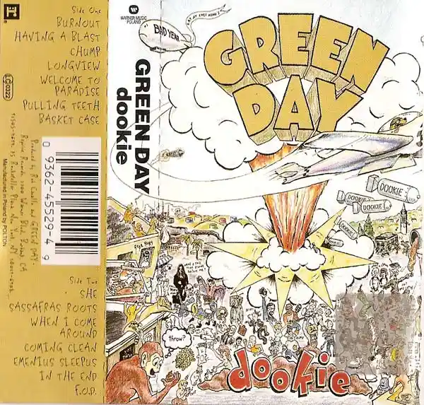 The image is the album cover for Green Day's 'Dookie,' featuring a chaotic, hand-drawn illustration of a cityscape with a…