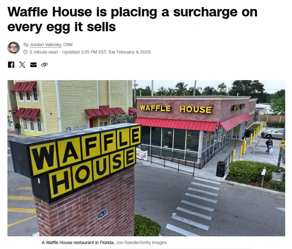 An exterior photo of a Waffle House restaurant with its iconic yellow and black sign on a brick pillar and red awnings. The…
