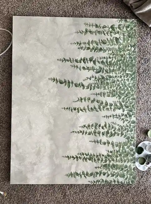A painting on canvas depicts green, leafy vines cascading from the top right corner against a textured gray background, laid…