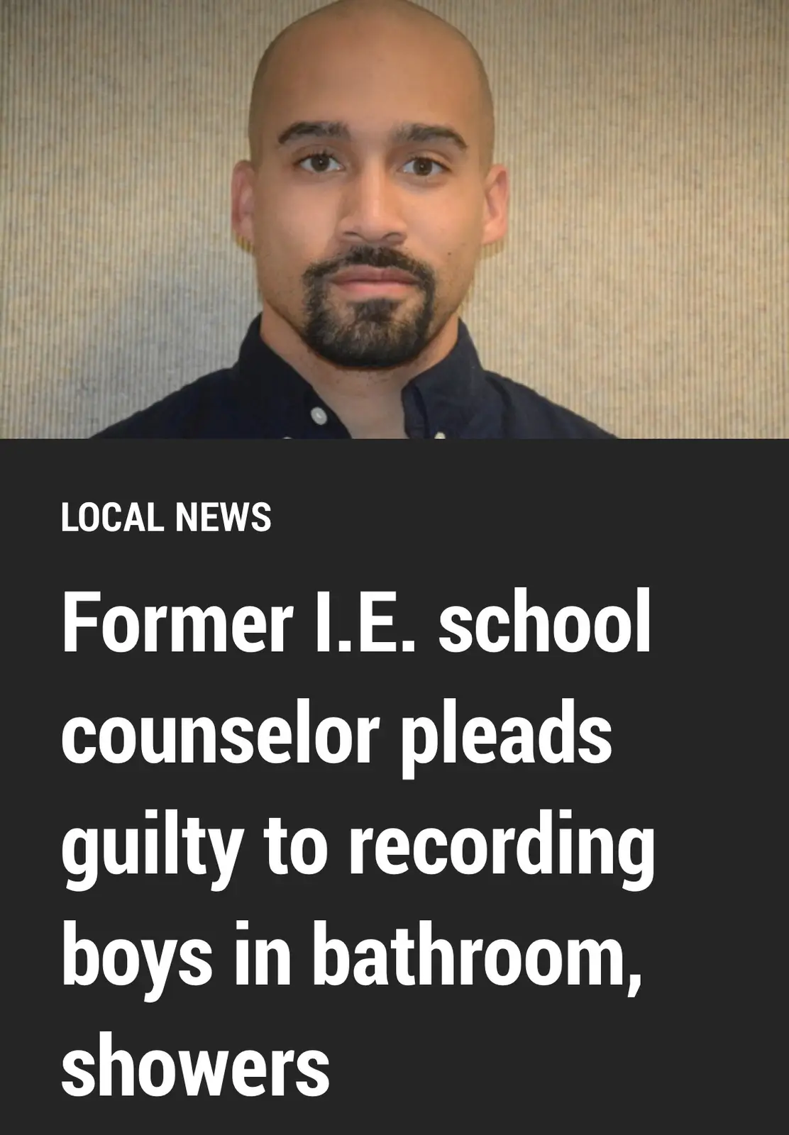 A mugshot-style photo of a bald man with a goatee wearing a dark collared shirt against a textured beige wall. Overlaid text…