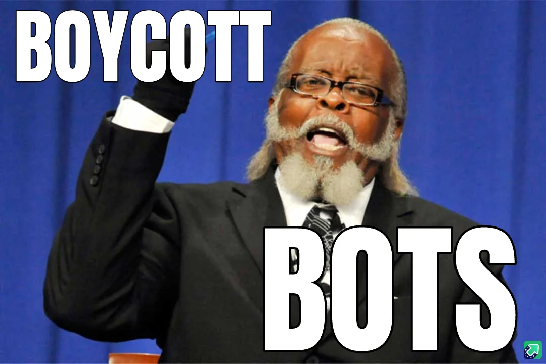 A man in a black suit and glasses, with a white beard, raises his gloved right hand emphatically against a blue curtain…