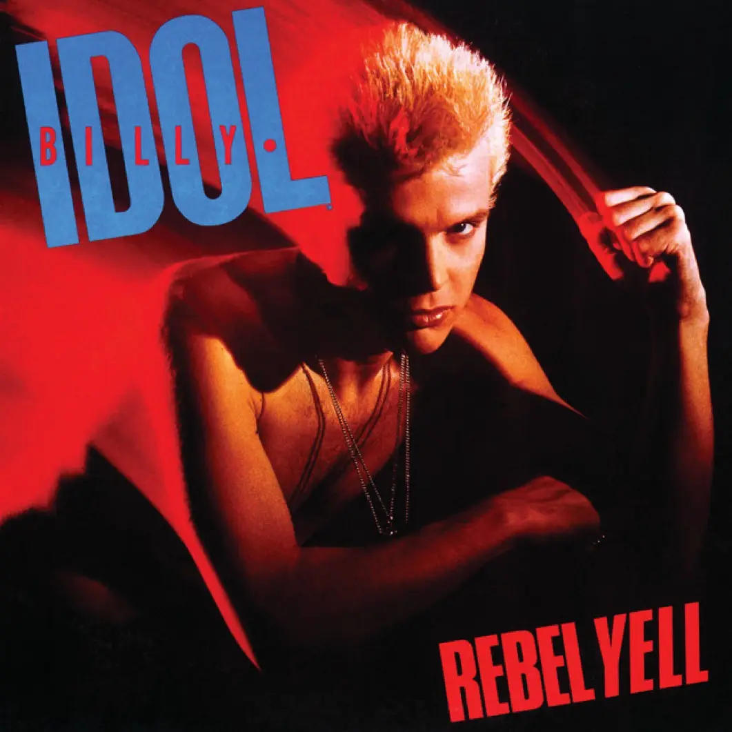 The image is the album cover for Billy Idol's 'Rebel Yell,' featuring the artist with spiky blonde hair, wearing layered…