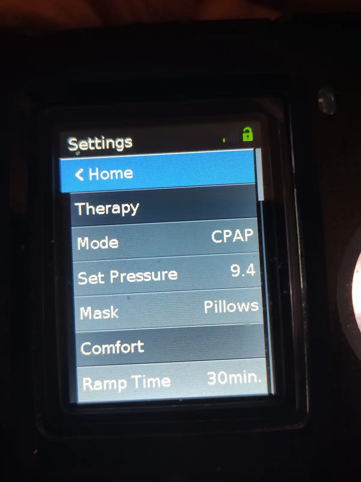 A close-up of a CPAP machine's settings screen showing 'Mode: CPAP', 'Set Pressure: 9.4', 'Mask: Pillows', and 'Ramp Time…