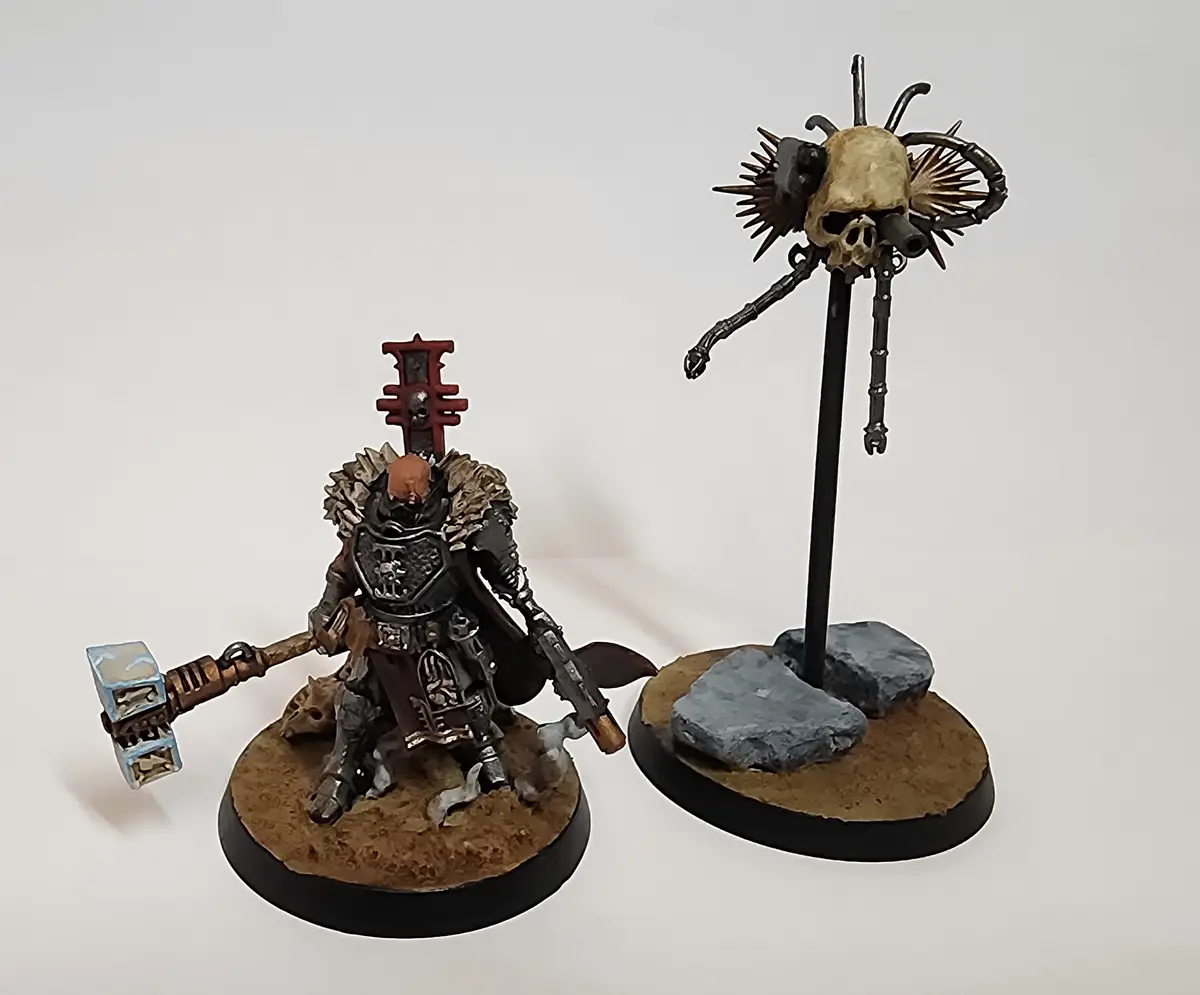 Two painted miniature figures from a tabletop wargame are shown side-by-side against a plain white background. The figure on…