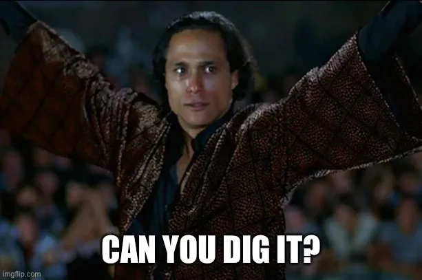 A man with dark curly hair and a patterned brown robe stands with arms outstretched, looking upward with a confident…