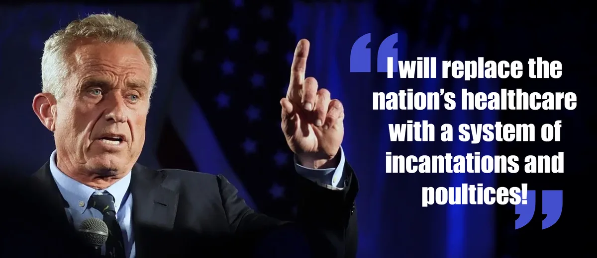A man in a suit and tie stands at a podium with an American flag in the background, pointing upward with his index finger…