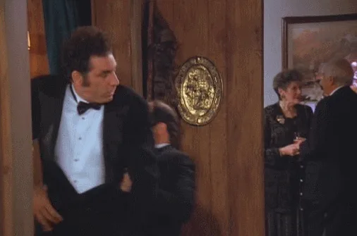 A six-panel sequence from the movie 'The Godfather' shows a man in a tuxedo, initially standing at a doorway, then…