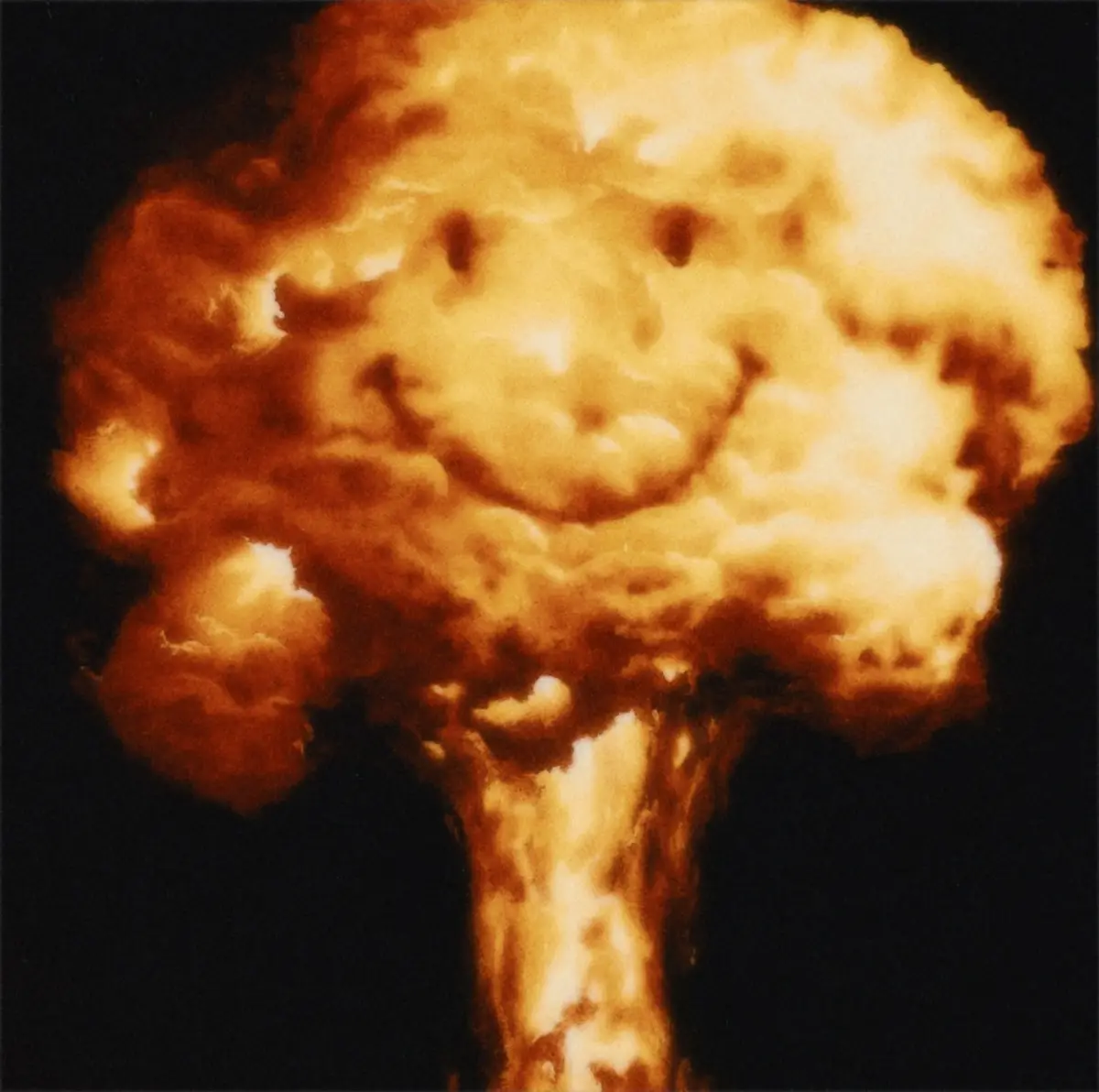 A photograph of a large, fiery nuclear explosion against a dark background, where the mushroom cloud's shape resembles a…