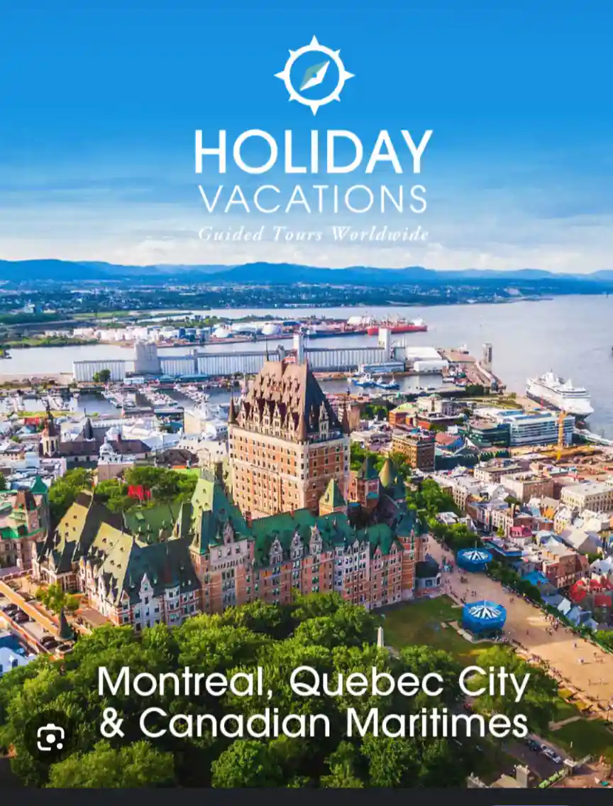 An aerial photo of a scenic Canadian cityscape featuring historic buildings, a river, and distant mountains under a clear…