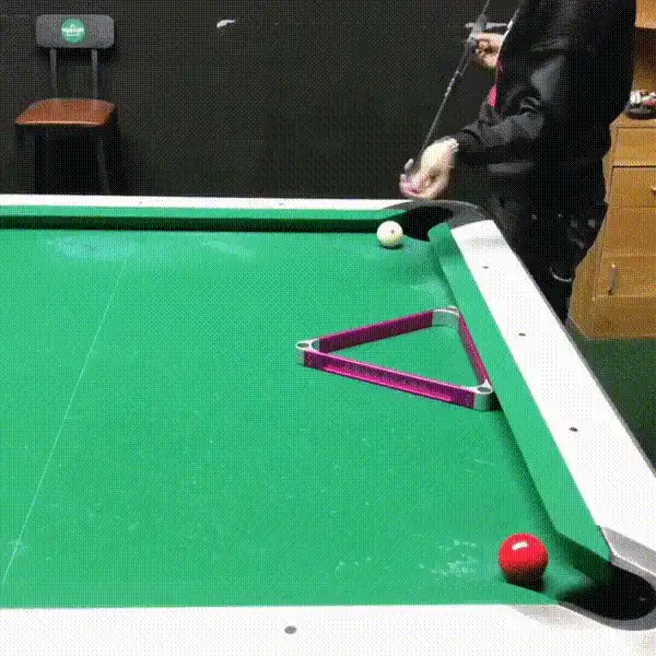 A grid of six panels shows a person at a pool table preparing to shoot, then a white and orange cat walks onto the table and…