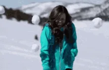 A sequence of six images shows a person in a teal winter jacket standing in a snowy landscape, progressively getting hit by…