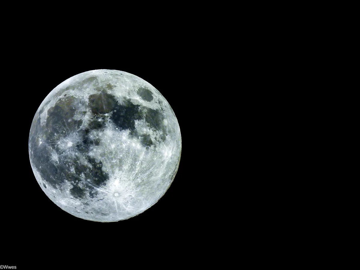 A high-resolution image of the full moon against a solid black background, showing detailed craters and maria. Overlaid text…